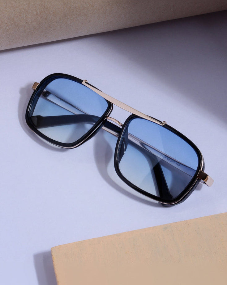 Sunglasses with black frames and blue lenses on a light purple surface