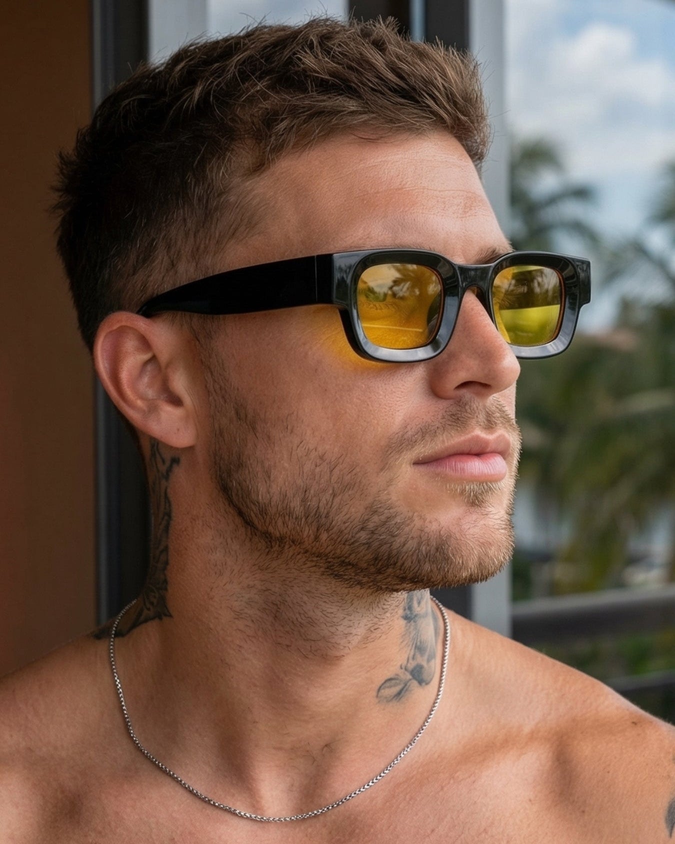 Man wearing sunglasses with a blurred outdoor background