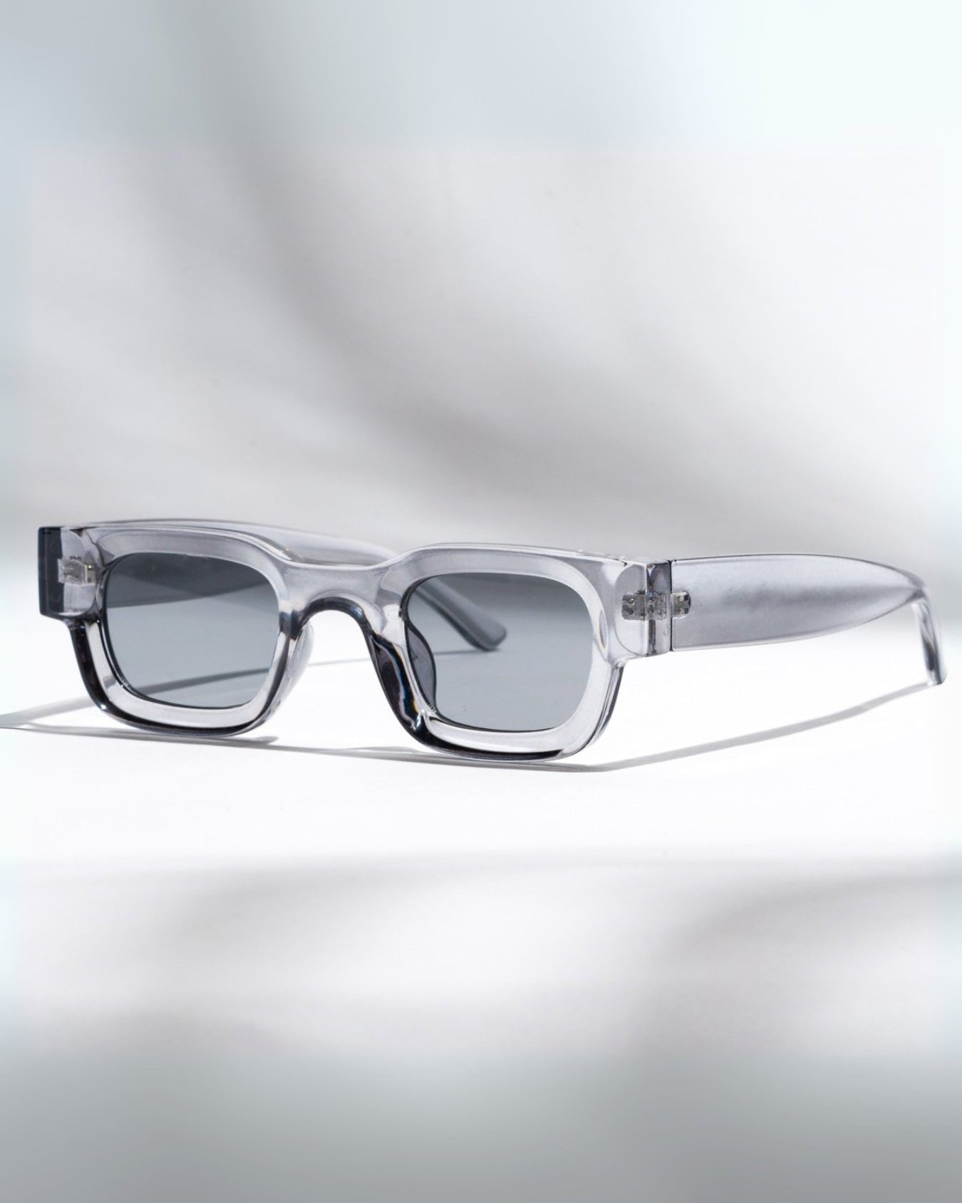 Clear glasses with a gradient effect on a light gray background