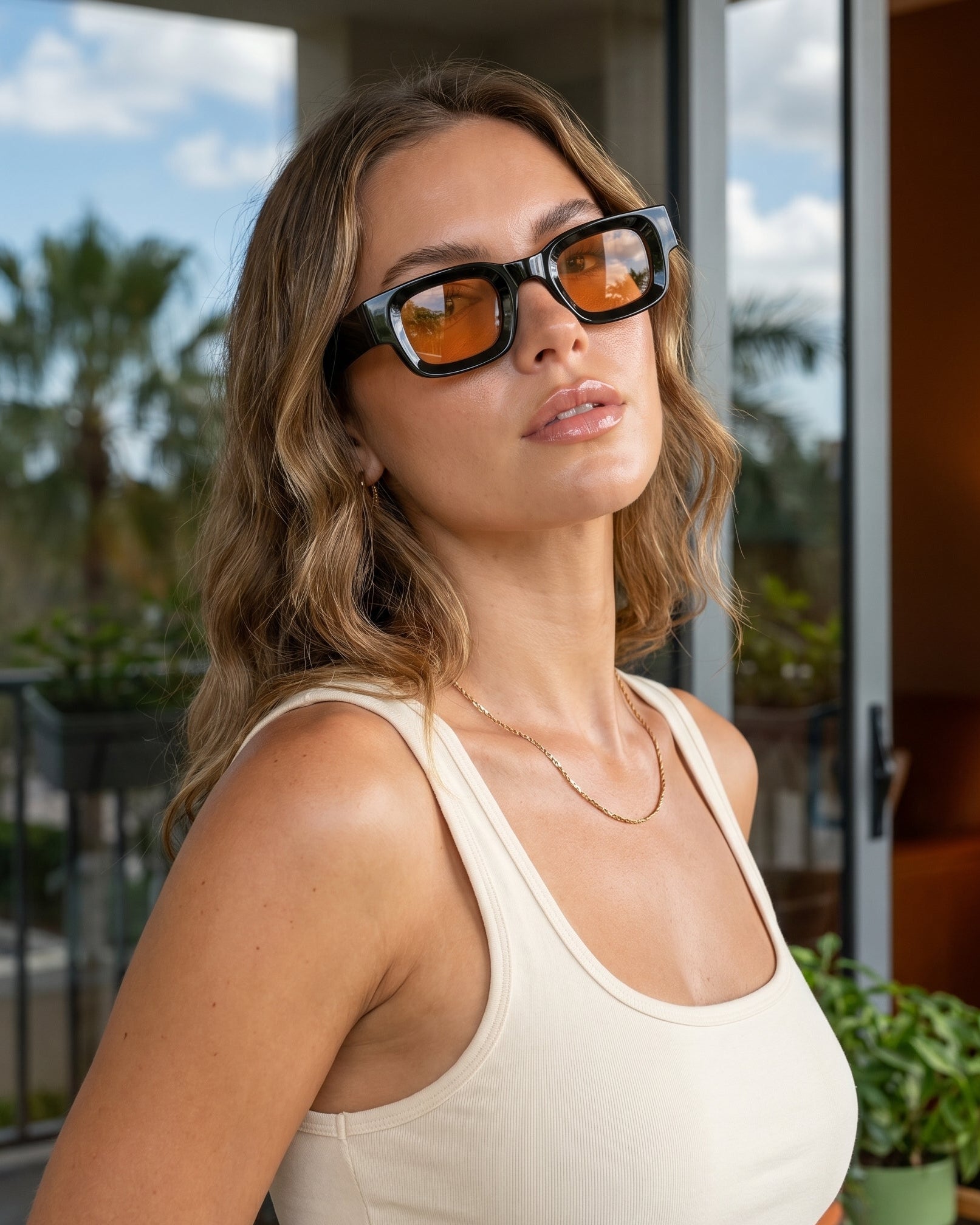 Woman wearing sunglasses with a blurred outdoor background